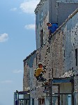 Монтажники высотники утепляют стены в Торезе